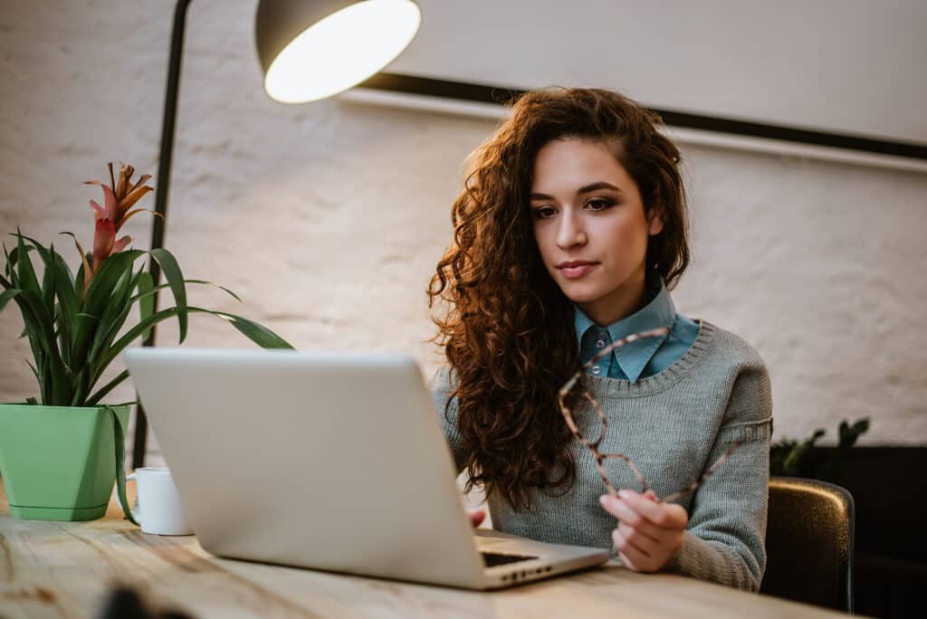 Young red haired woman concentrating on her laptop