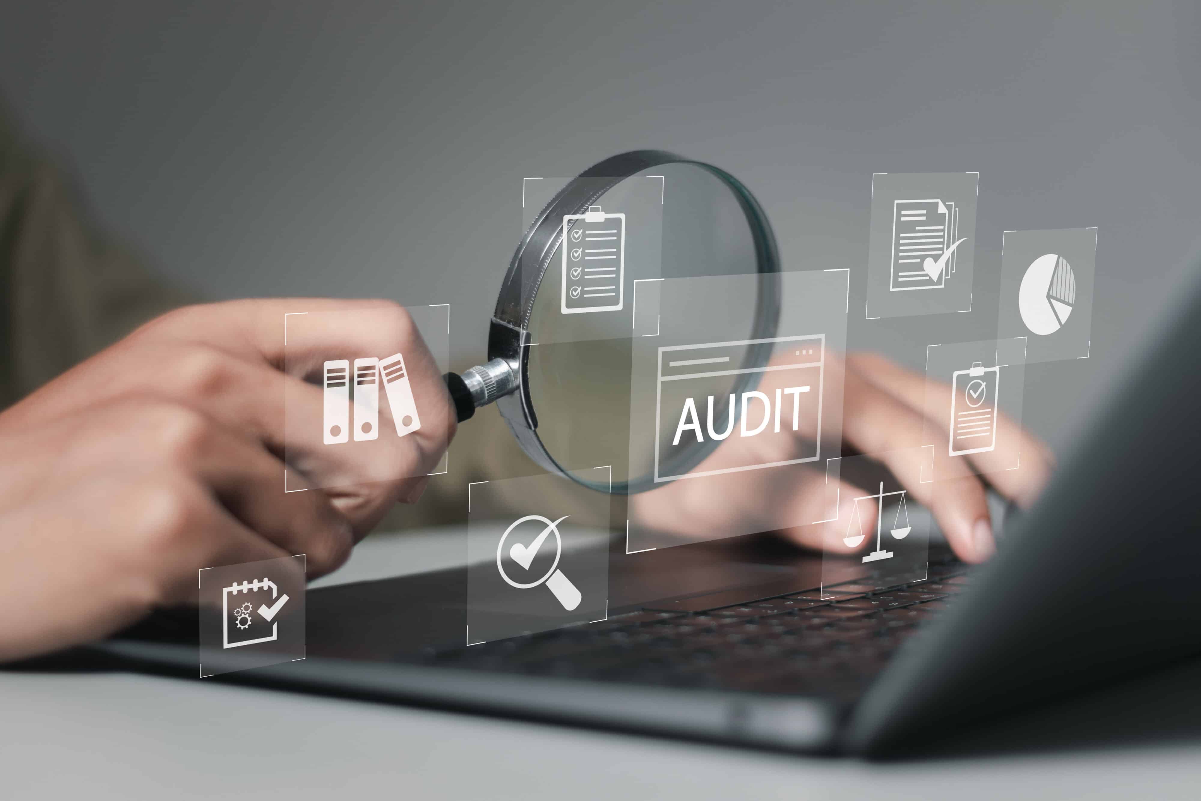 Businessman using laptop computer to audit and evaluate corporate financial statements for Audit business concept. Auditing financial accounts within the organization.