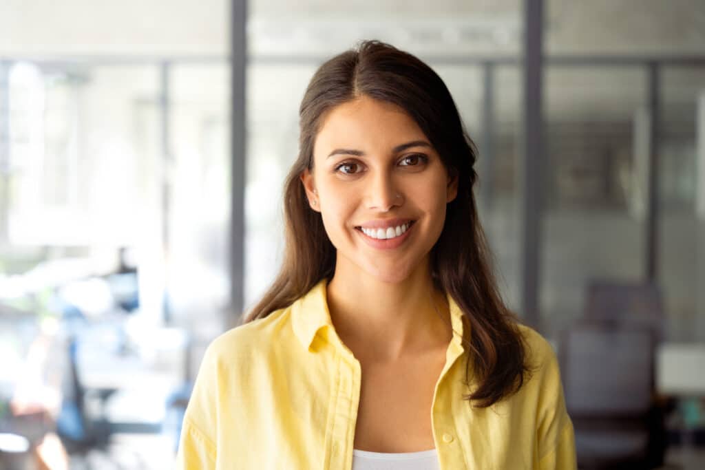 Closeup headshot portrait of cheerful smiling latin hispanic female